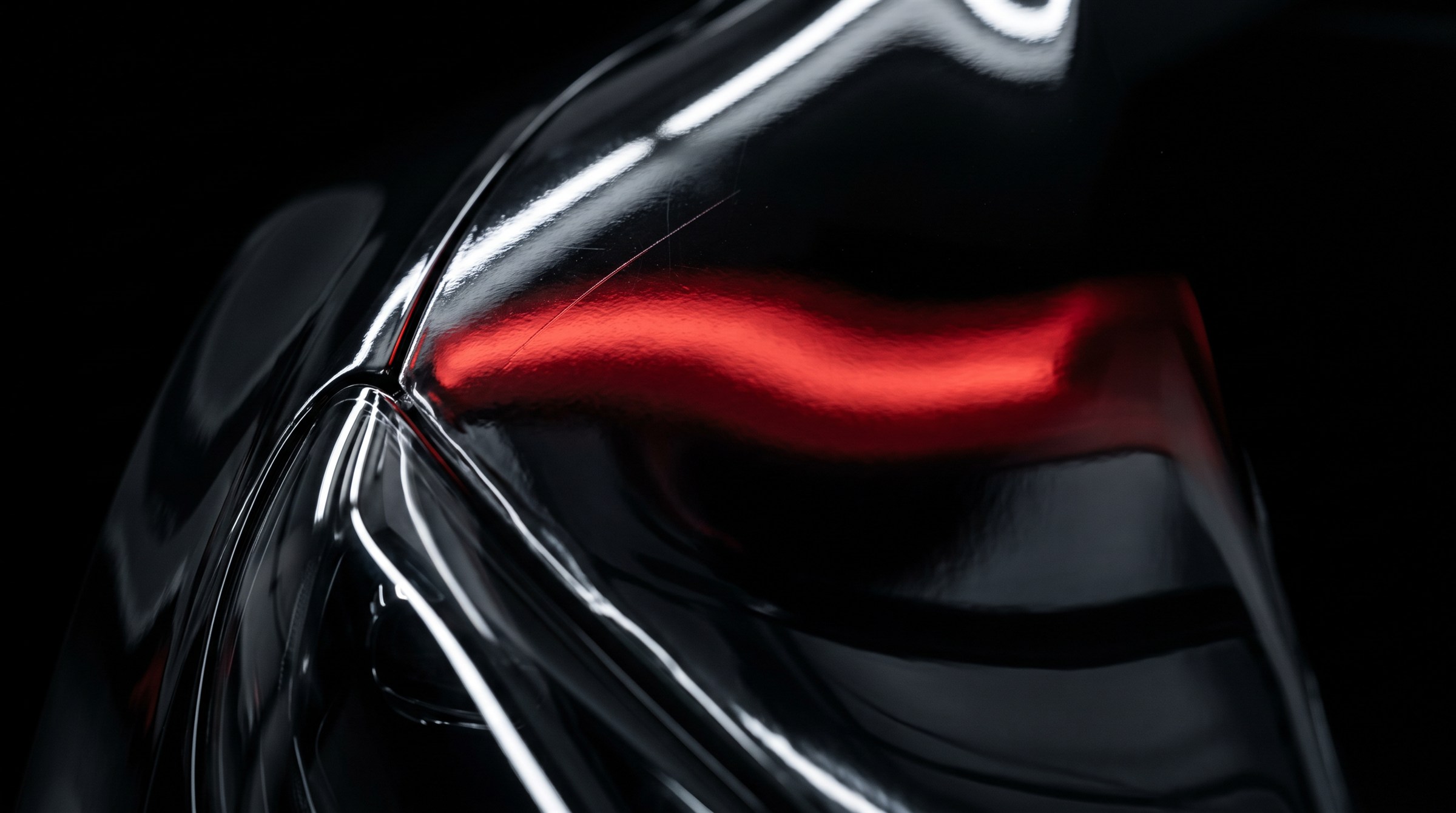 Macro detail of a clear protection film edge beside a car headlight