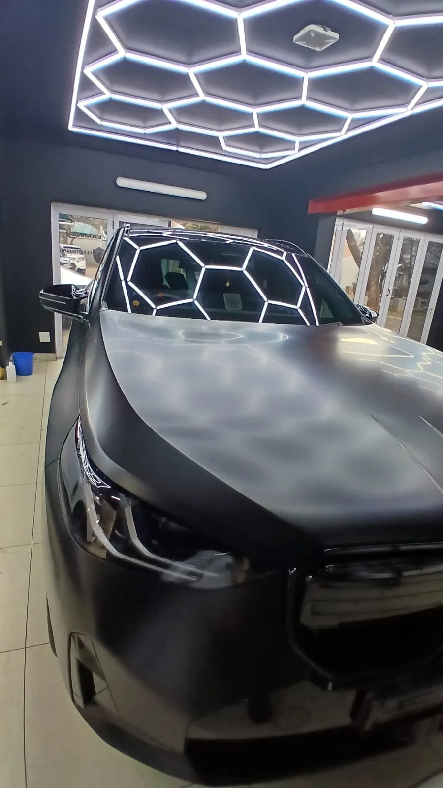 Protected silver car bonnet inside the ClearGuard workshop