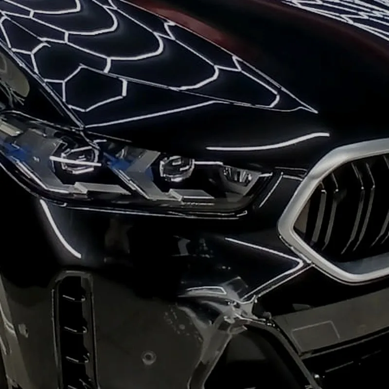 Glossy black BMW bonnet, headlight and grille detail